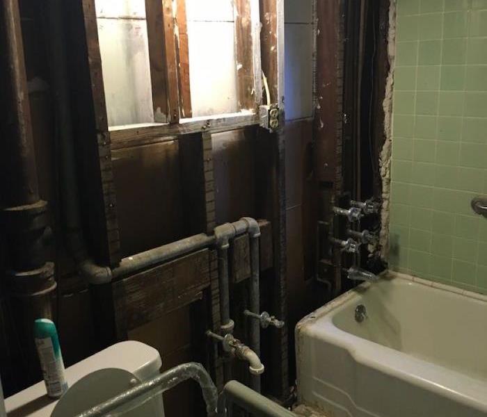 Bathroom with much of the structure removed and framework exposed