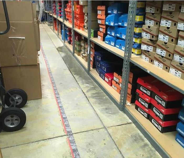 Shoe store with stock and water damage on floor