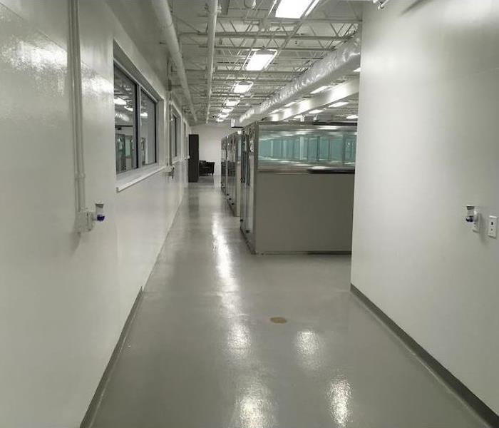 Office walkway with concrete floors and cubicles