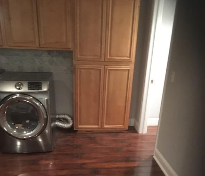 Laundry room with water on the floor