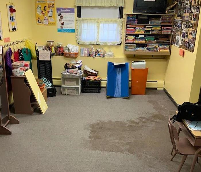 Children's daycare room with wet carpet