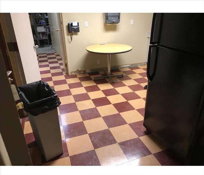 Breakroom with table showing baseboards removed