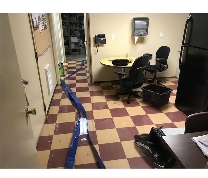 Breakroom with commercial water damage on tile floor