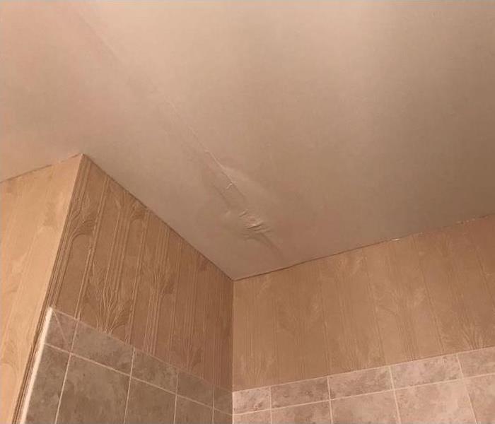 Bathroom ceiling with paint bubble