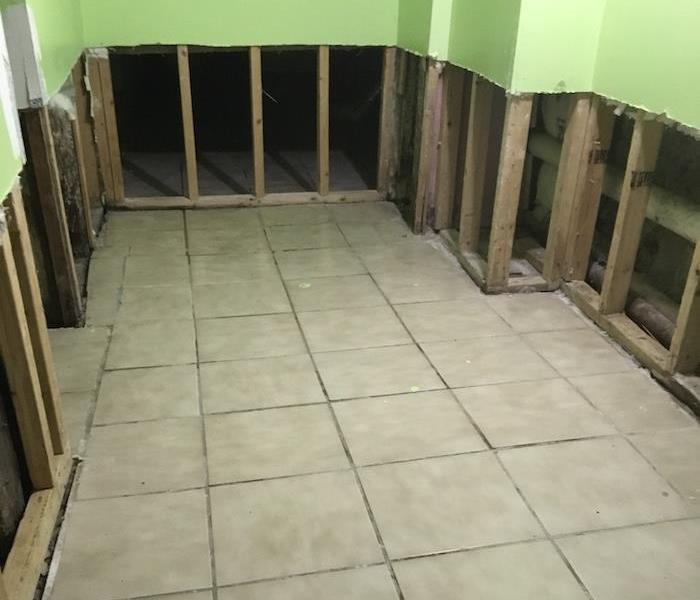 Tile floor in a room with flood cuts on sheetrock